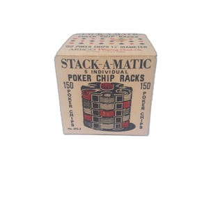 May include: A vintage "STACK-A-MATIC" box for poker chip racks. The box is tan with red and black graphics, including an illustration of stacked poker chips. Text on the box indicates it holds 150 poker chips, 1.5" in diameter.