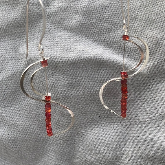 Stacked c-curve earrings in argentium sterling silver with red-orange sapphire