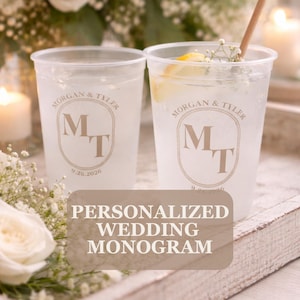 May include: Two clear plastic cups filled with a clear liquid, ice, and a lemon wedge. Each cup is printed with a monogram design and the names "Morgan & Tyler" and the date "9.26.2026". The text "PERSONALIZED WEDDING MONOGRAM" is displayed.