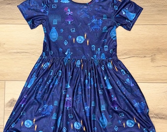 May include: A dark blue dress with a scoop neckline and short sleeves. The dress features a repeating pattern of ghostly figures, tombstones, and candles. The skirt is gathered at the waist, creating a flared silhouette. The dress is made of a soft, flowing fabric.