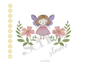 May include: An embroidered design of a cartoon fairy with brown hair, purple wings, and a pink dress, framed by pink flowers and green leaves. The design includes the text "SC studio" and "3 SIZES".