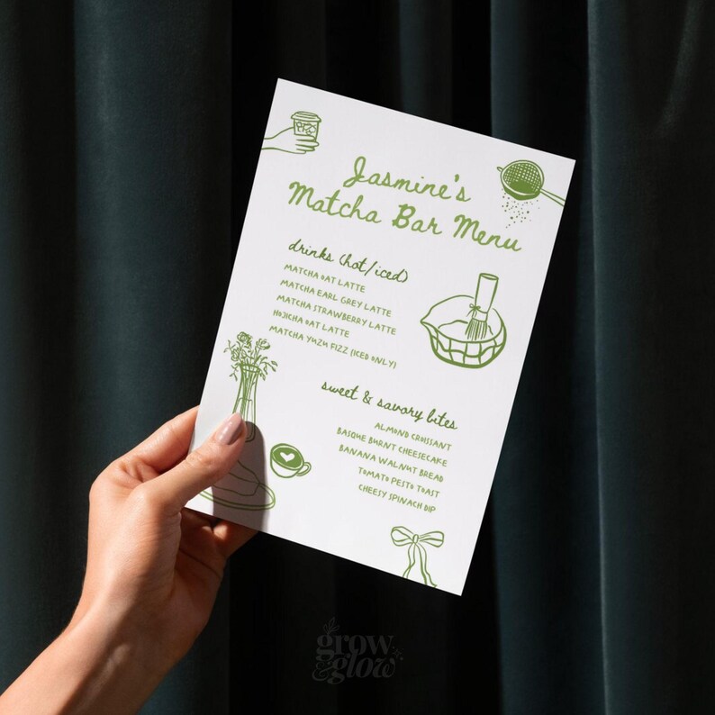 May include: A white menu titled "Jasmine's Matcha Bar Menu" with green text and illustrations. The menu lists matcha drinks and sweet and savory bites. The menu is held by a person.