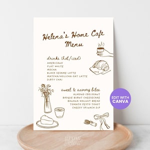 以下が含まれることがあります： 「Helena's Home Cafe Menu」と題された手書き風のカフェメニュー。コーヒー、クロワッサン、その他の食べ物のイラストが特徴です。リストには、ホットとコールドのドリンク、甘くておいしい軽食が含まれています。デザインにはCanvaボタンが含まれています。