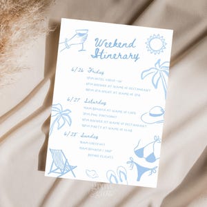 May include: A white paper with a light blue weekend itinerary. The text includes dates, times, and activities. Decorative illustrations of a cocktail, sun, palm tree, hat, bikini, beach chair, and flip-flops are included.