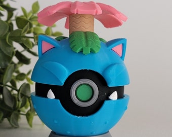 May include: A blue and grey 3D printed Pokemon figure of a Snorlax with a pink flower on top. The figure is standing on a grey base.