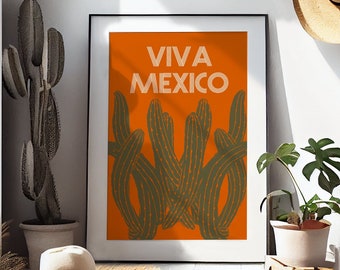 May include: A framed print with an orange background and green cactus silhouettes. The text "Viva Mexico" is printed in white on the print.