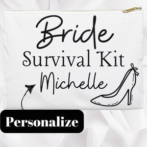 May include: White canvas cosmetic bag with a gold zipper, featuring the text "Bride Survival Kit Michelle" in black script. A high-heeled shoe graphic is on the right. A black rectangle at the bottom says "Personalize".