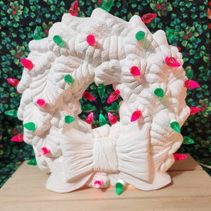 Ceramic Bisque Christmas Wreath Nowell, clip in light not included, medium twist bulbs are included.