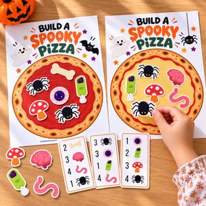 May include: Two Build a Spooky Pizza activity sheets featuring a large pizza graphic with red sauce and crust. Includes cut-out stickers of spiders, a bone, an eyeball, a brain, a worm, and a mushroom, plus three numbered instruction cards.