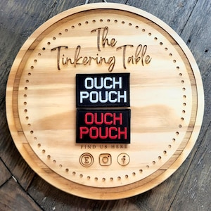 May include: A set of three ceramic mugs with a speckled, matte finish. The mugs are in shades of cream, light brown, and dark brown. Each mug has a simple, minimalist design and a rounded handle.