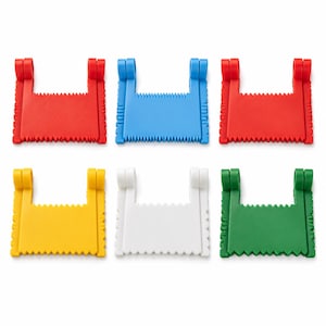 Pode incluir: Um conjunto de seis raspadores de bolo de plástico nas cores vermelho, azul, vermelho, amarelo, branco e verde. Cada ferramenta apresenta um corpo retangular com bordas serrilhadas no topo e na base, e dois braços laterais com alças circulares.