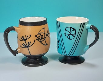 Vintage blue and tan footed mugs, hand painted with fish and squiggle designs