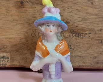 Tiny vintage porcelain half doll, demure lady in orange shawl and blue hat