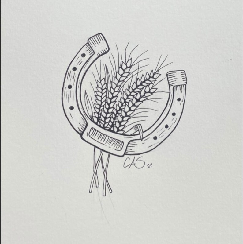 May include: A black and white line drawing of a horseshoe with wheat stalks inside. The drawing is signed "CAS 21"