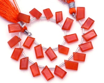 May include: A strand of carnelian gemstone beads, each bead is a rectangular shape with a pointed edge. The beads are strung on silver wire and are approximately 18 inches long.