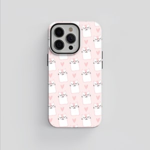 May include: A pink and white phone case with a repeating pattern of white cats with pink hearts. The case has a camera cutout and a black outline.