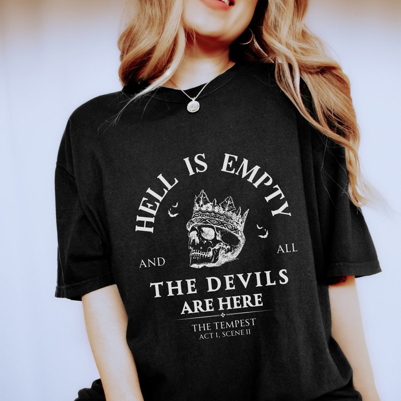 May include: Black t-shirt with a white graphic print of a skull wearing a crown. The text reads "Hell is empty and all the devils are here."  The text "The Tempest Act I, Scene II" is also printed on the shirt.