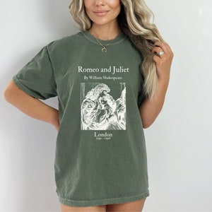 May include: A green t-shirt with a white print of a book cover featuring the title "Romeo and Juliet" by William Shakespeare. The book cover also includes a black and white illustration of a couple embracing and the text "London 1791 - 1796".