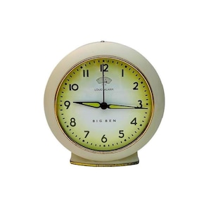 May include: Cream-colored, retro-style alarm clock with a round face and a gold-colored trim. The clock face is yellow with black numerals and hands. The words "BIG BEN" and "LOUD ALARM" are printed on the face.