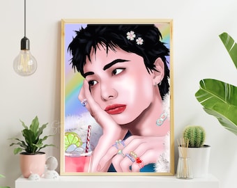 May include: A framed art print featuring a stylized portrait of a person with black hair adorned with flowers. The person is wearing multiple rings and has a drink with a straw. The background includes a rainbow and the artwork is in a wooden frame.