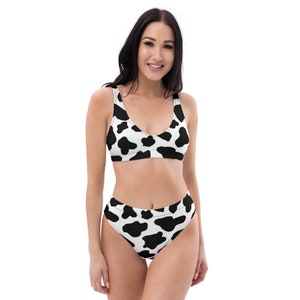 May include: A black and white cow print bikini with a high-waisted bottom.