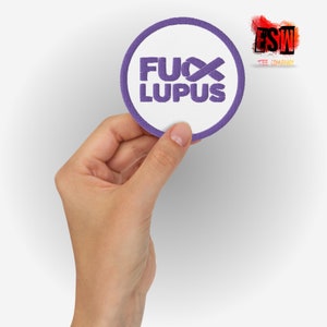 May include: Purple and white round embroidered patch with the text "FUX LUPUS" and a purple ribbon.