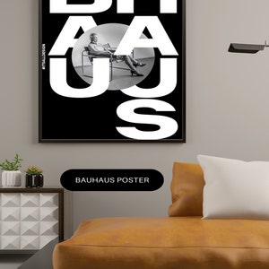 May include: Black and white poster with the word "BAHAUS" in large white letters. The letters are layered on top of each other, and a person is sitting in a chair in the middle of the poster. The poster has the hashtag "#ITSALLDESIGN" in the bottom left corner.