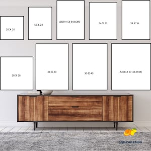 May include: A wall gallery featuring nine different sized picture frames with various measurements in inches and centimeters. The frames are arranged in a staggered pattern on a white wall above a wooden dresser.