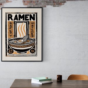 Pode incluir: Um cartaz de estilo vintage com o texto "Ramen" em letras pretas em negrito. O cartaz apresenta uma tigela de ramen com macarr&atilde;o, ovos e uma pe&ccedil;a de alga marinha. A tigela &eacute; cercada por uma borda preta e branca com um padr&atilde;o repetitivo. O cartaz tamb&eacute;m inclui o texto "Safety Matches" e "25&cent; per box" e "5&cent;".