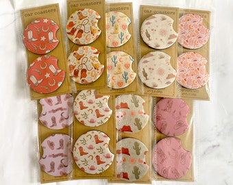 May include: Set of 12 round car coasters with various designs featuring cacti, horseshoes, and cowboy hats. The coasters are made of absorbent material and are perfect for protecting your car's cup holders from spills and condensation.