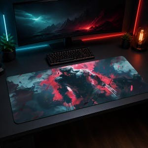 May include: A rectangular desk mat featuring a graphic illustration of a character with metallic claws extending from their hands. The design uses a high-contrast colour palette of deep black, vibrant red, and muted teal with a smoky, abstract background.