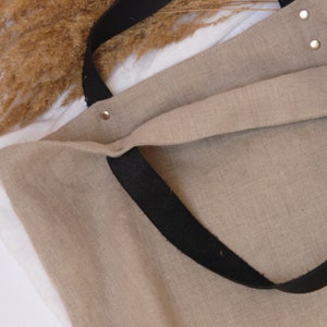Beige linen tote bag with black leather straps