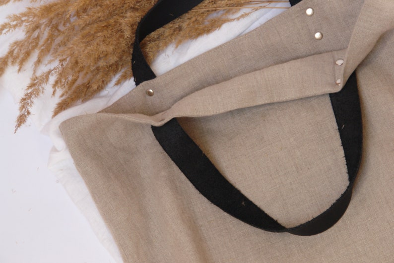 Beige linen tote bag with black leather straps
