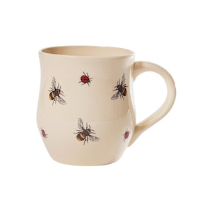 May include: A cream-coloured ceramic mug with a handle. The mug features a bee and ladybug design.