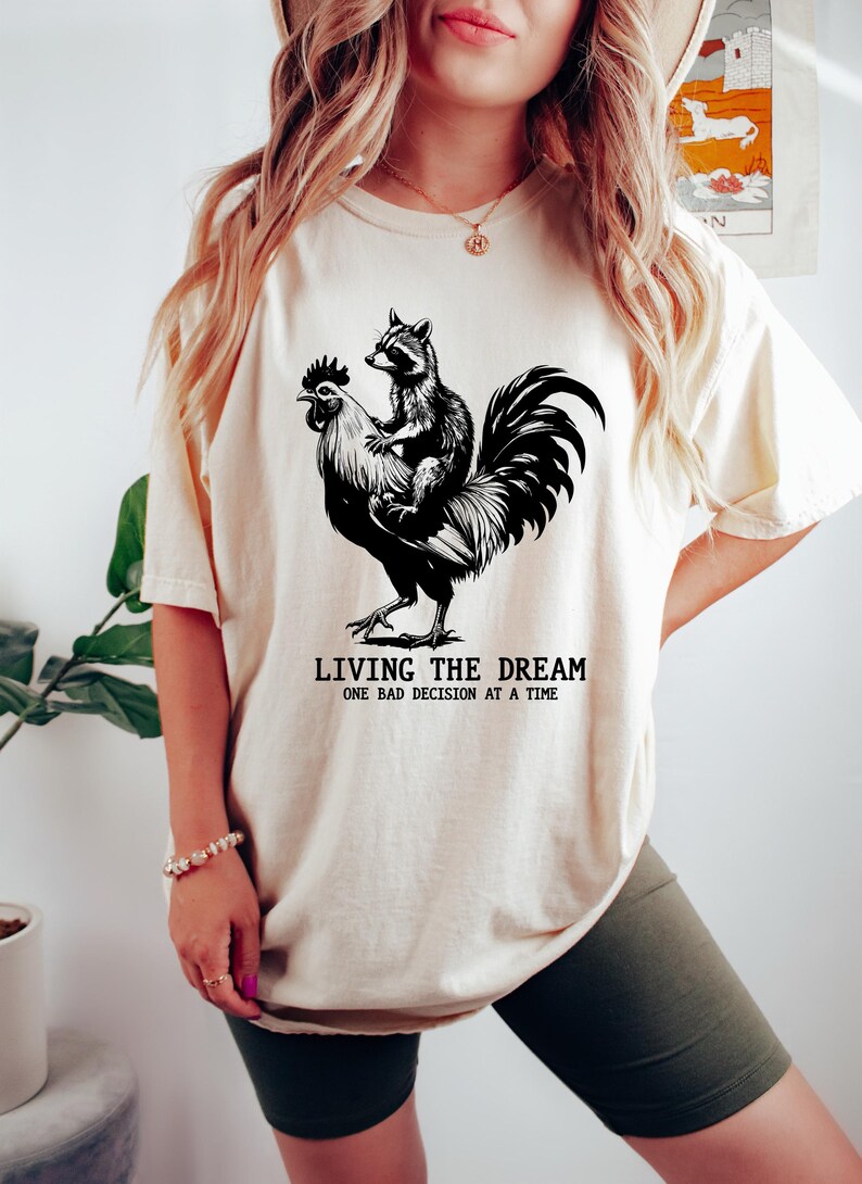 Person Riding A Roster Living the Dream Chicken Raccoon Shirt, Funny Farm Animal Graphic Tee ...