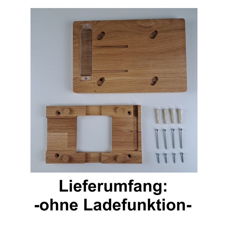 May include: A wooden wall mount for a tablet or phone. The mount is made of light brown wood and has a rectangular cutout for the device. The mount comes with screws and anchors for installation. The text "Lieferumfang: -ohne Ladefunktion- " is visible in the image.