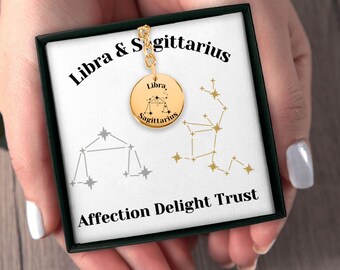 May include: Gold necklace with a round pendant featuring the zodiac signs Libra and Sagittarius. The pendant is in a black box with the words "Libra & Sagittarius" and "Affection Delight Trust".