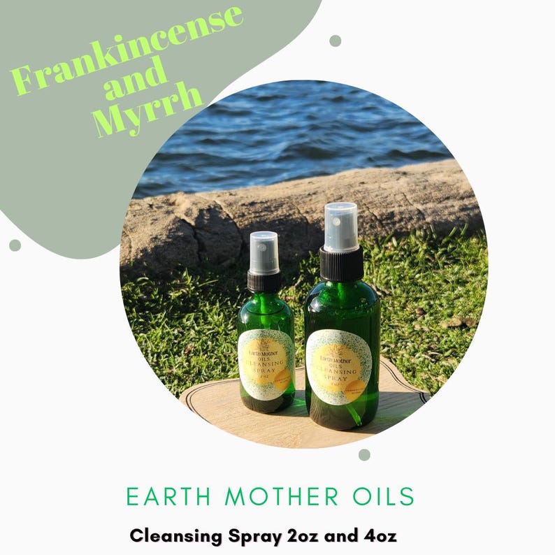 May include: Two green glass spray bottles of Earth Mother Oils Cleansing Spray, labeled 2oz and 4oz, are displayed on a wooden surface. The text "Frankincense and Myrrh" is above the bottles. The background features water and grass.