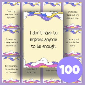 May include: A set of 100 affirmation cards with inspirational quotes. The cards have a light yellow background with a cloud and star design. The text on the cards includes phrases like "I'm enough" and "I can grow."