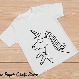 May include: A white t-shirt with a black line drawing of a unicorn on it. The unicorn has a horn, mane, and tail.