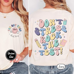 May include: Ivory unisex t-shirt with a smiley face and the text "You got this #test day" on the front and the text "Don't stress rock the test!" on the back.