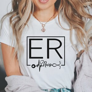 May include: White t-shirt with a black square graphic that says "ER Nurse" with a stethoscope and heartbeat graphic underneath.