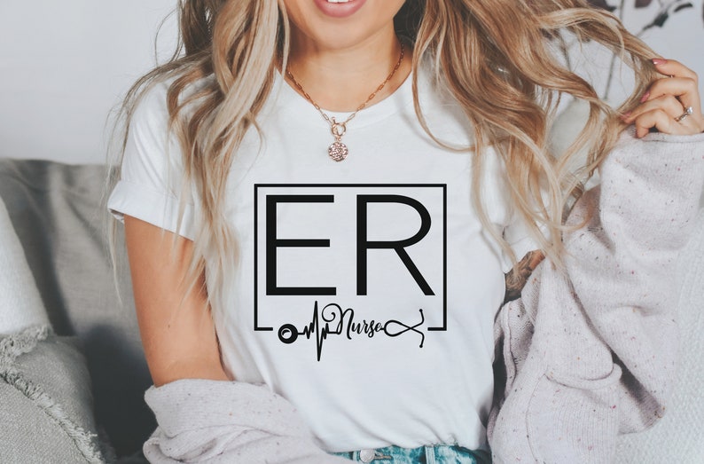 May include: White t-shirt with a black square graphic that says "ER Nurse" with a stethoscope and heartbeat graphic underneath.