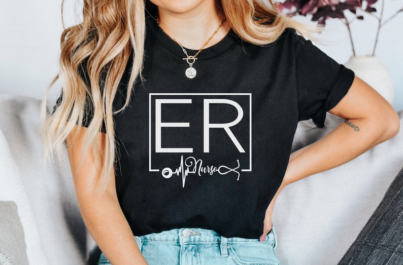 May include: Black t-shirt with a white graphic design that says "ER Nurse" with a heartbeat and stethoscope graphic.