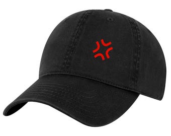 May include: A black baseball cap featuring a small, red, four-pointed angular symbol embroidered on the front center. The cap has a curved brim, a structured crown with stitched panels, and a button at the top, presenting a clean, minimalist look.