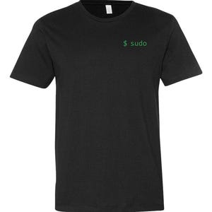 May include: A black short-sleeved t-shirt featuring a crew neckline and the text $ sudo printed in green on the upper left chest area. The garment is displayed flat against a plain white background, showcasing a simple and clean design.