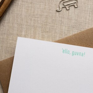 May include: A white card with a brown envelope. The card has the text 'ello, guvna!' printed in green.
