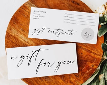 May include: A white gift certificate with the text "gift certificate" and a logo placeholder. The certificate is on a wooden surface with green leaves.