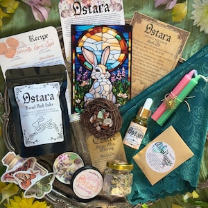 May include: An assortment of Ostara-themed ritual items, including bath salts, candles, oils, and a stained-glass rabbit. The items are arranged on a decorative silver tray with flowers and cards. The image includes the text "Ostara".
