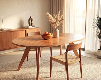 Extendable round solid wood dining table. Mid-century dining table